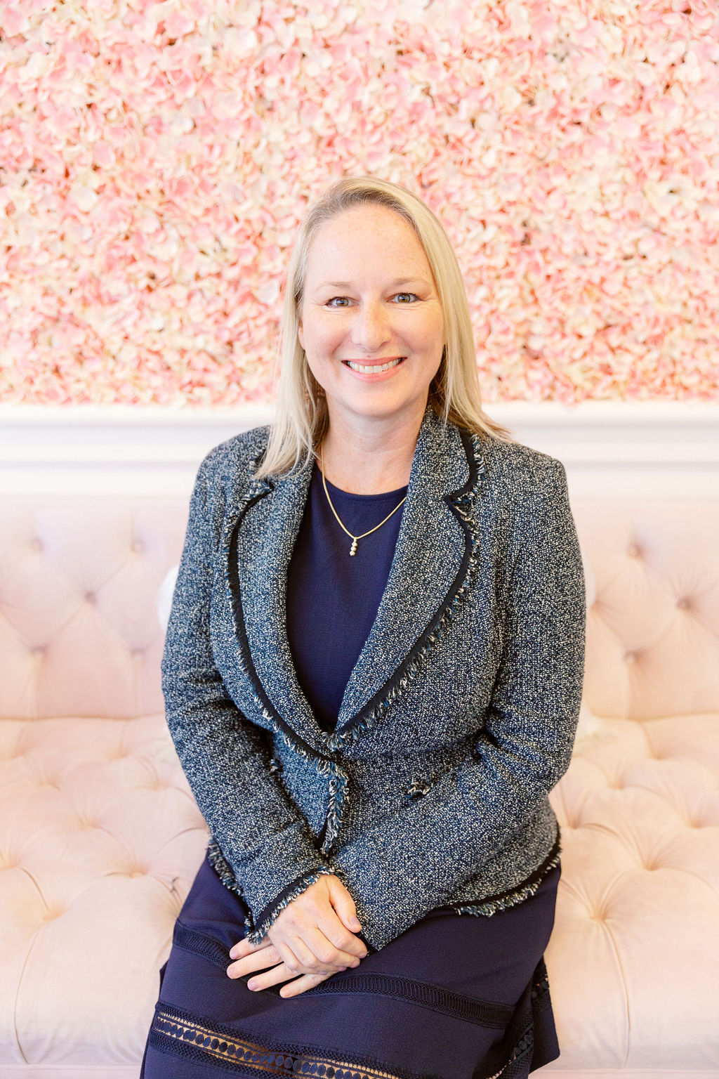 Owner Stephanie wearing a black blazer with floral blouse