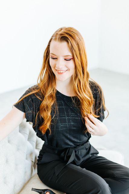 Bridal Stylist Brittany wearing a stripped black blouse and black pants