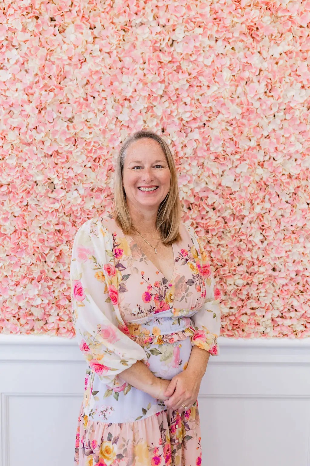 Owner Stephanie wearing a black blazer with floral blouse