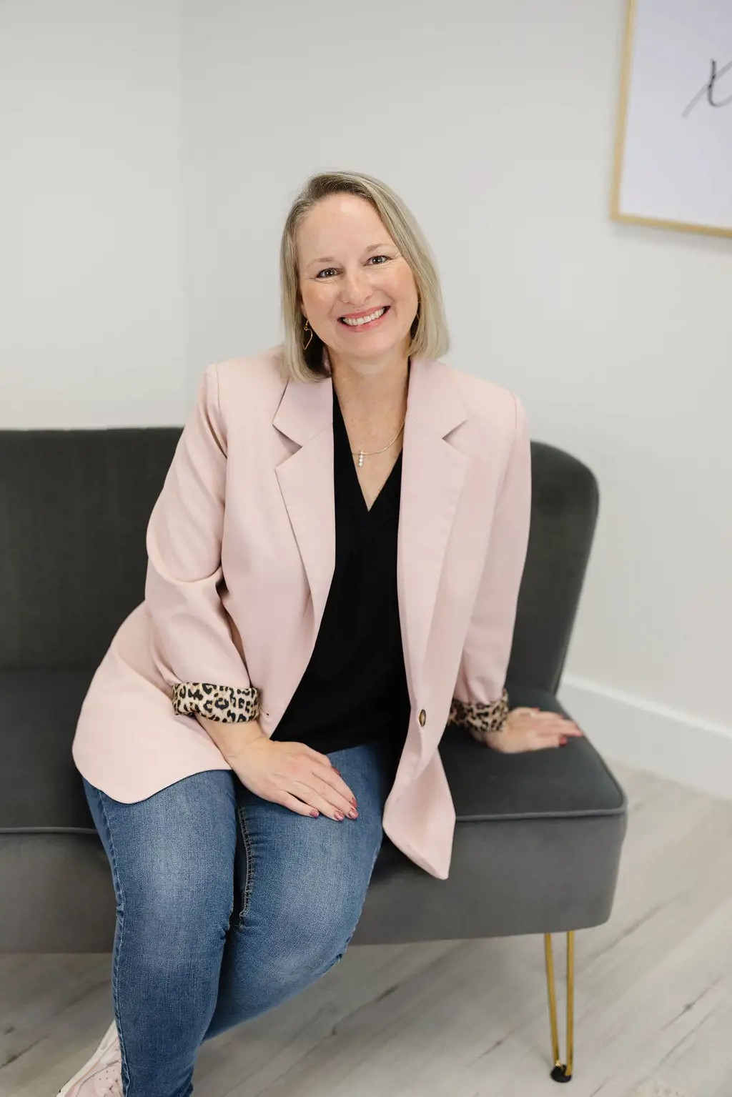 Owner Stephanie wearing a black blazer with floral blouse