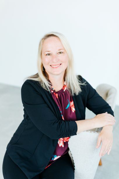 Owner Stephanie wearing a black blazer with floral blouse